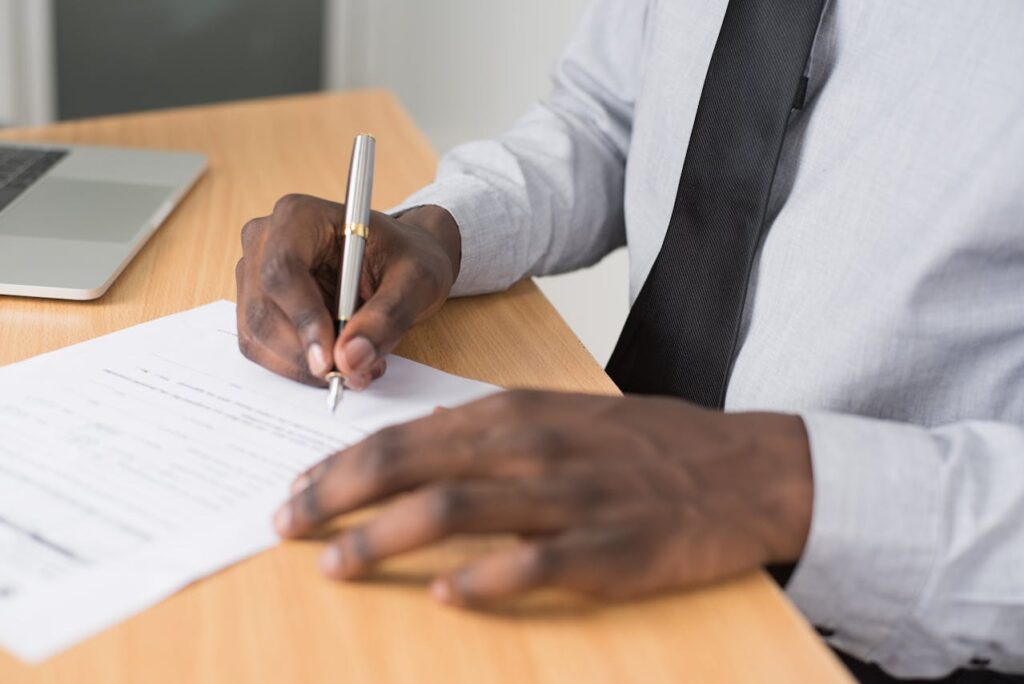 man-signing-hr-compliance-checklist